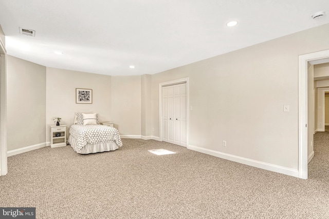 carpeted bedroom with a closet