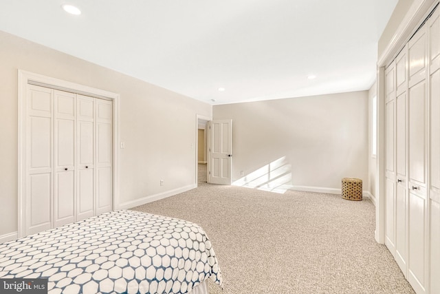 carpeted bedroom with two closets