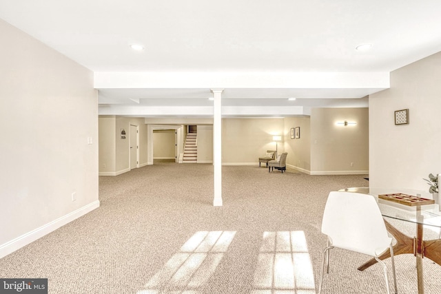 basement featuring light carpet