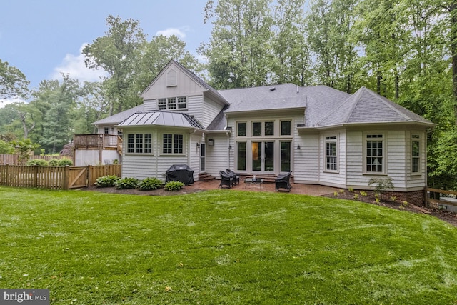 back of property with a yard and a patio area