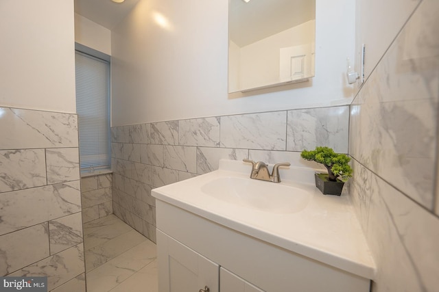 bathroom featuring vanity and tile walls