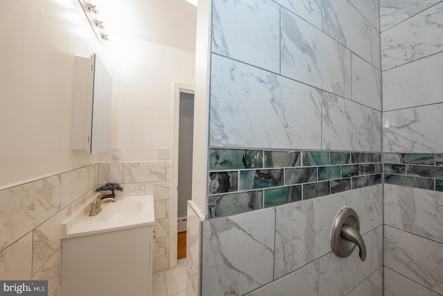 bathroom featuring vanity and tile walls