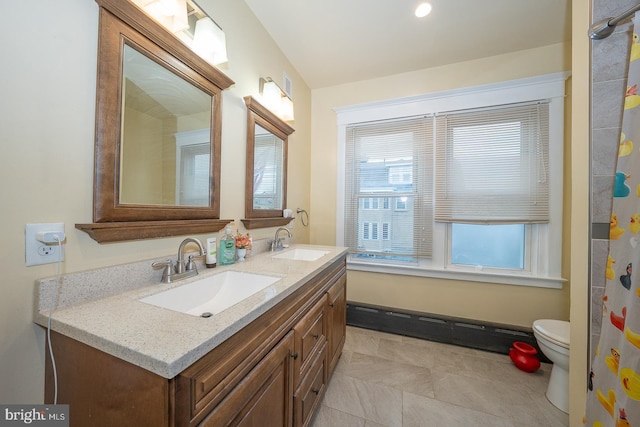 bathroom with tile patterned flooring, vanity, and toilet