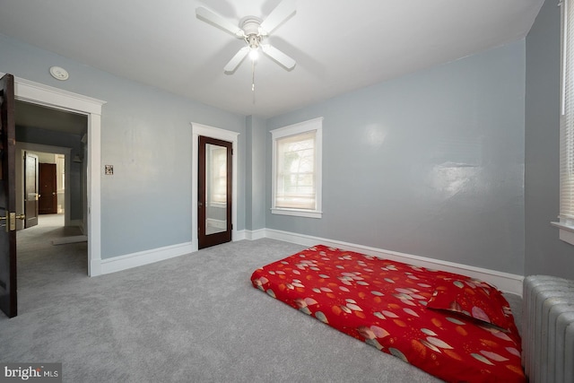 carpeted bedroom featuring ceiling fan and radiator heating unit