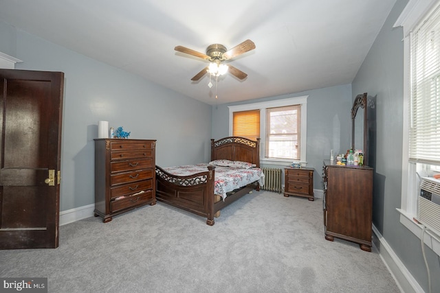 carpeted bedroom with radiator and ceiling fan