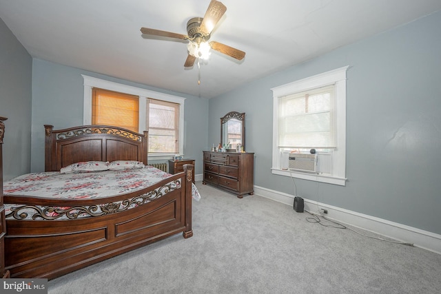 carpeted bedroom with multiple windows, ceiling fan, and cooling unit