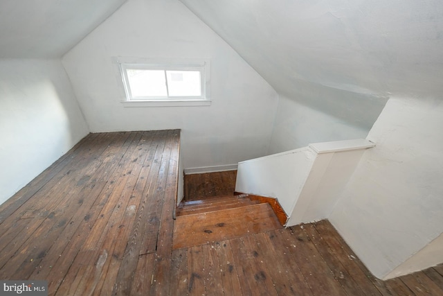 bonus room with dark hardwood / wood-style floors and lofted ceiling