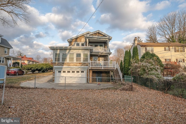 back of house featuring a balcony and a garage