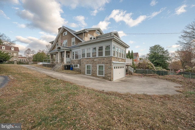 back of property featuring central air condition unit, a yard, and a garage