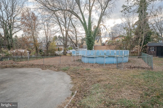 view of yard with a covered pool