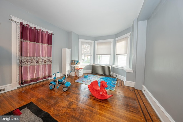 playroom featuring radiator heating unit and wood-type flooring