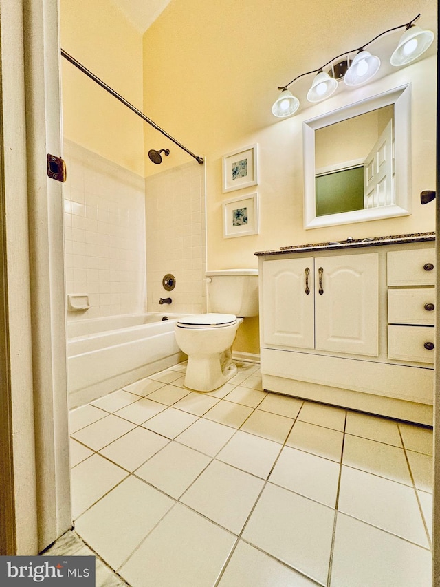 bathroom featuring tile patterned floors, tiled shower / bath combo, and toilet