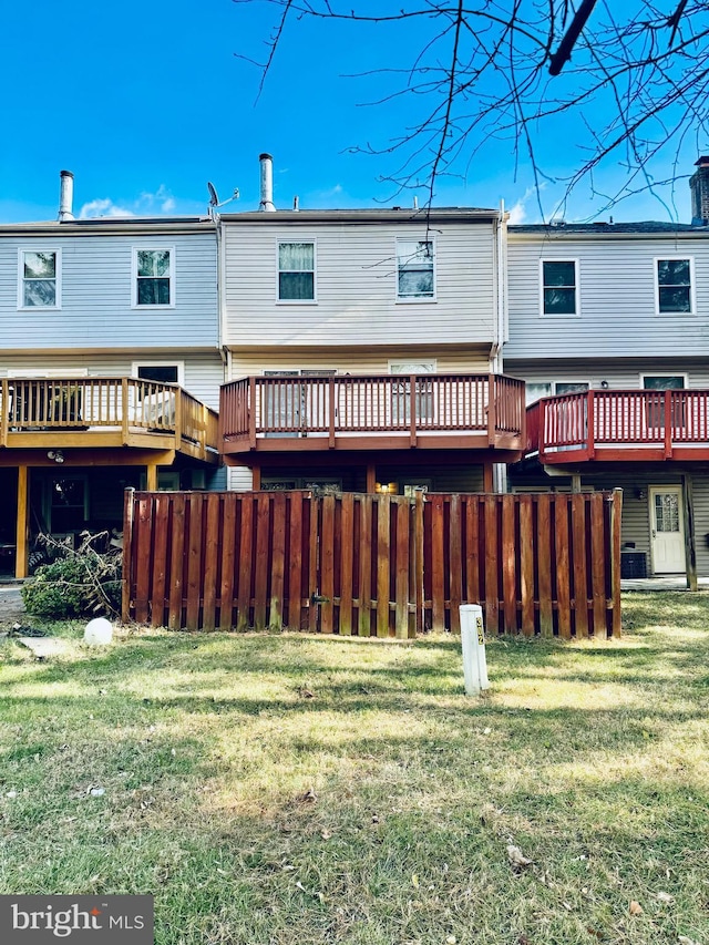 back of house with a lawn and central AC unit