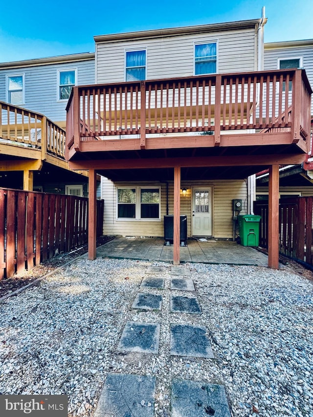 back of house with a patio, a deck, and central AC unit