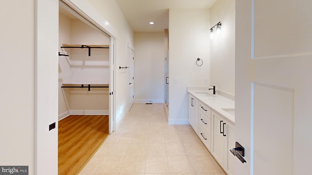 bathroom with hardwood / wood-style flooring and vanity