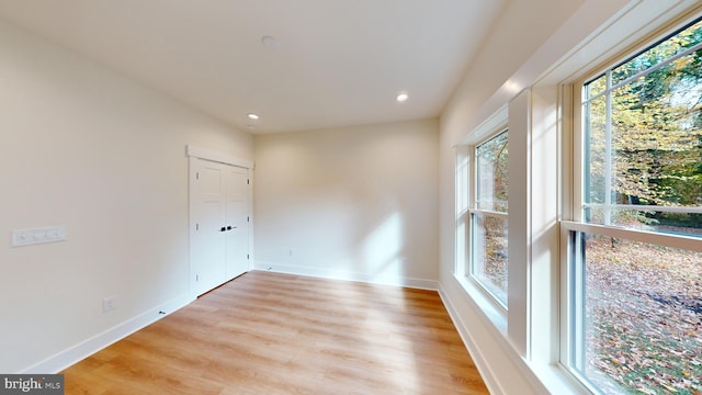 empty room with light hardwood / wood-style flooring