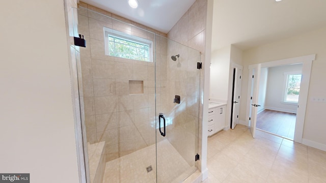 bathroom with tile patterned floors and an enclosed shower