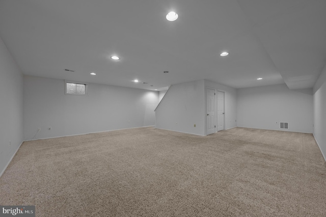 basement featuring light carpet