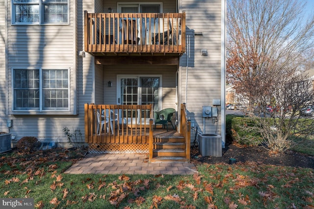 back of property featuring central AC and a balcony