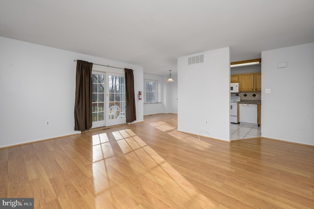 unfurnished living room featuring light hardwood / wood-style floors