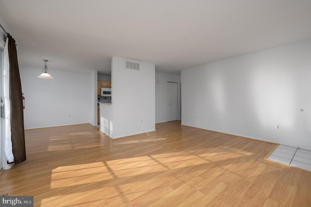 spare room with light hardwood / wood-style flooring