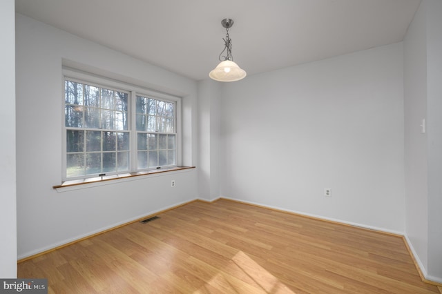 spare room featuring light hardwood / wood-style floors