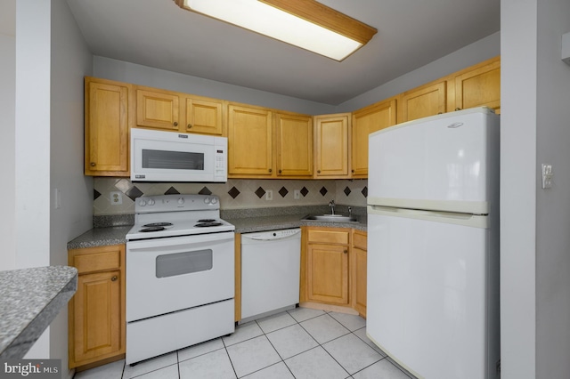 kitchen featuring decorative backsplash, light brown cabinetry, and white appliances