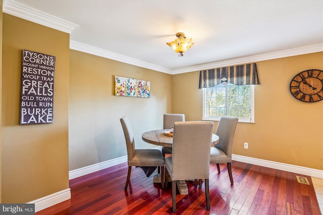 dining space featuring hardwood / wood-style floors and ornamental molding