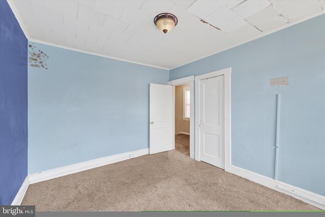 unfurnished bedroom featuring carpet and ornamental molding