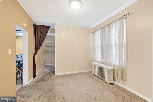 carpeted spare room with radiator