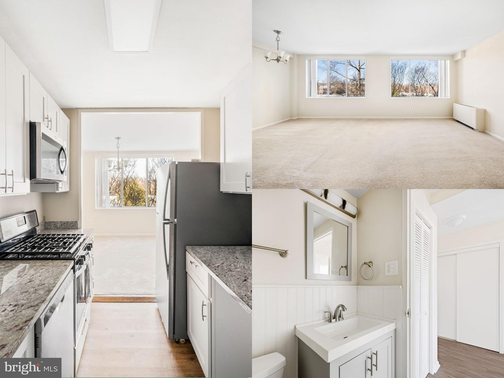 kitchen featuring pendant lighting, a chandelier, stainless steel appliances, white cabinets, and sink