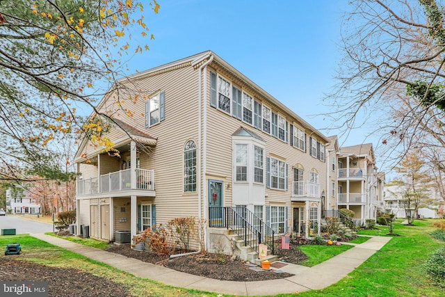 view of side of property with a balcony and cooling unit