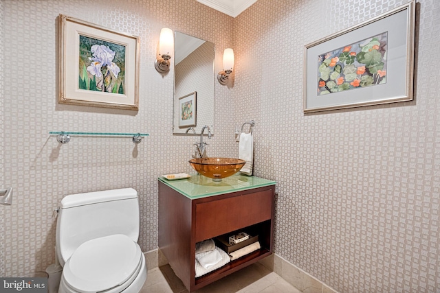 bathroom with tile patterned flooring, vanity, toilet, and ornamental molding