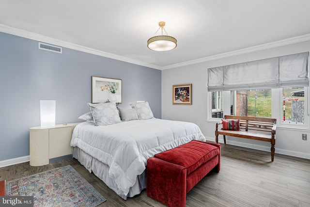 bedroom featuring hardwood / wood-style floors and crown molding