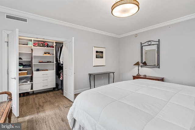 bedroom featuring hardwood / wood-style flooring, a closet, and ornamental molding