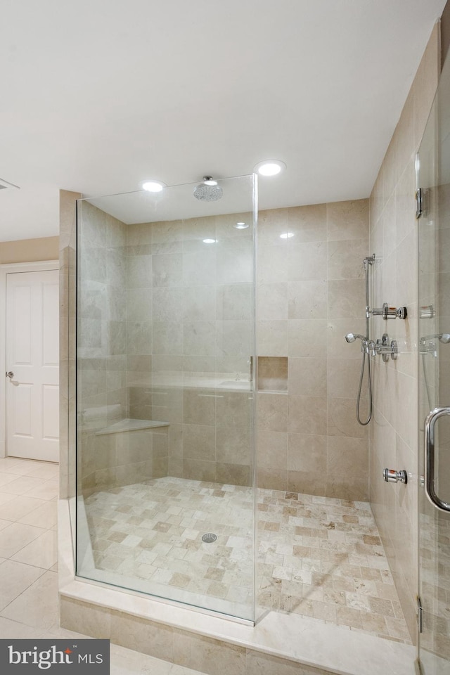 bathroom with tile patterned flooring and walk in shower