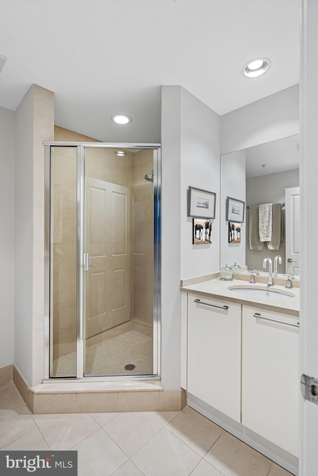 bathroom with tile patterned floors, vanity, and walk in shower