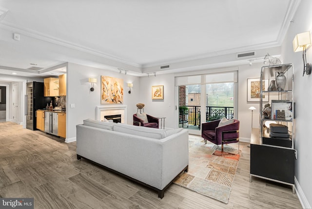 living room with hardwood / wood-style floors and ornamental molding