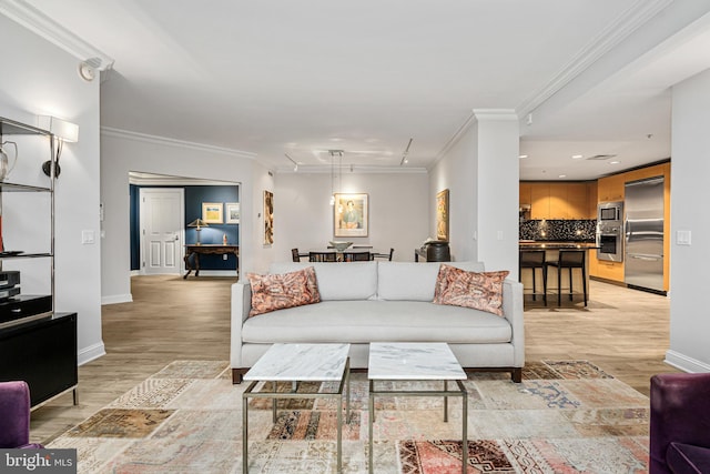 living room with crown molding and light hardwood / wood-style flooring