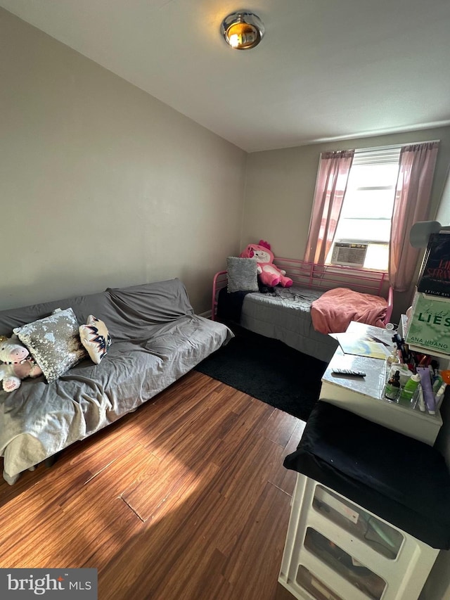 bedroom with dark hardwood / wood-style flooring and cooling unit