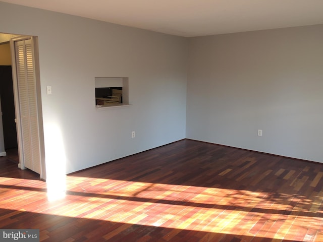 unfurnished room with hardwood / wood-style flooring