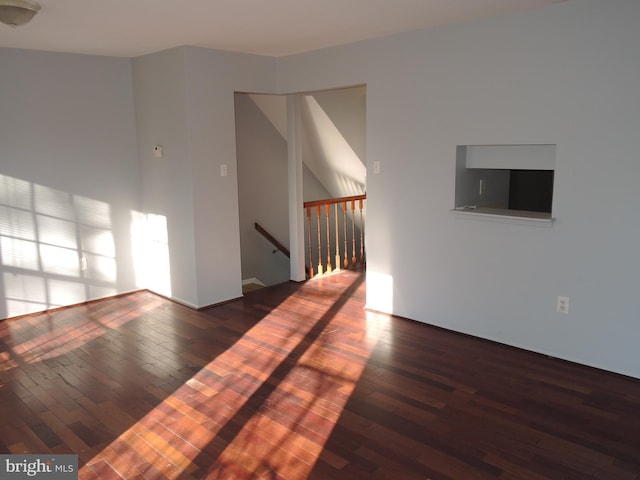 unfurnished living room featuring dark hardwood / wood-style floors