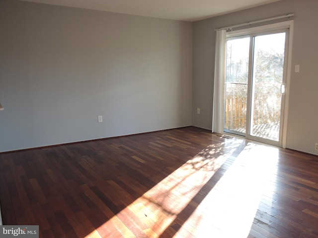 empty room with dark wood-type flooring