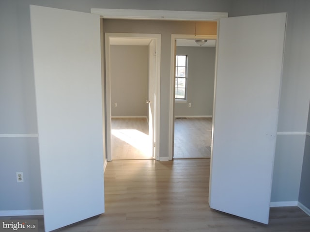 hallway with light wood-type flooring