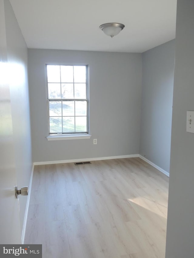 unfurnished room featuring light wood-type flooring