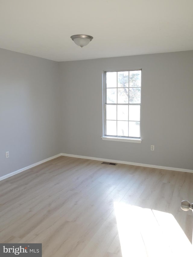 empty room with light hardwood / wood-style floors