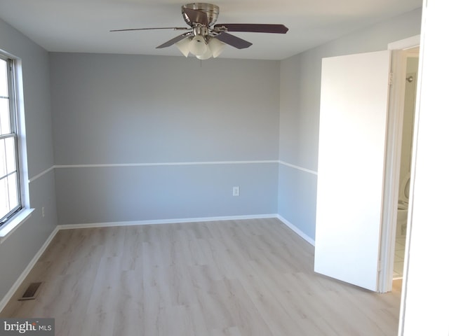 empty room with ceiling fan and light wood-type flooring