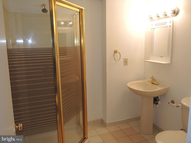 bathroom featuring toilet, tile patterned floors, and walk in shower