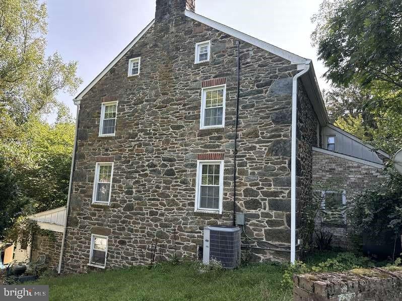 view of side of property featuring central AC