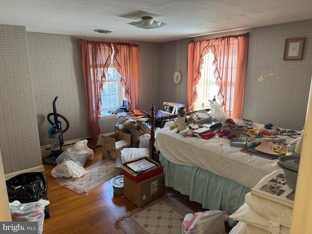 707 Wheatley Dr, Westminster, MD 21157 - bedroom featuring visible vents, wood finished floors, and wallpapered walls